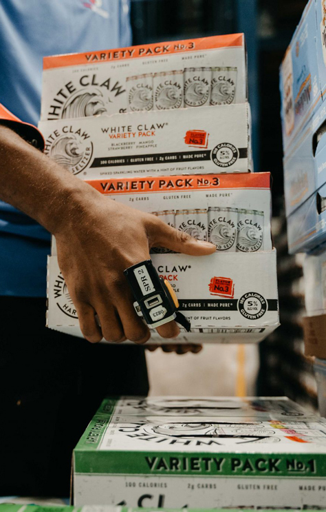 LongBev12_Desktop Close up of an employee stacking cases of White Claw