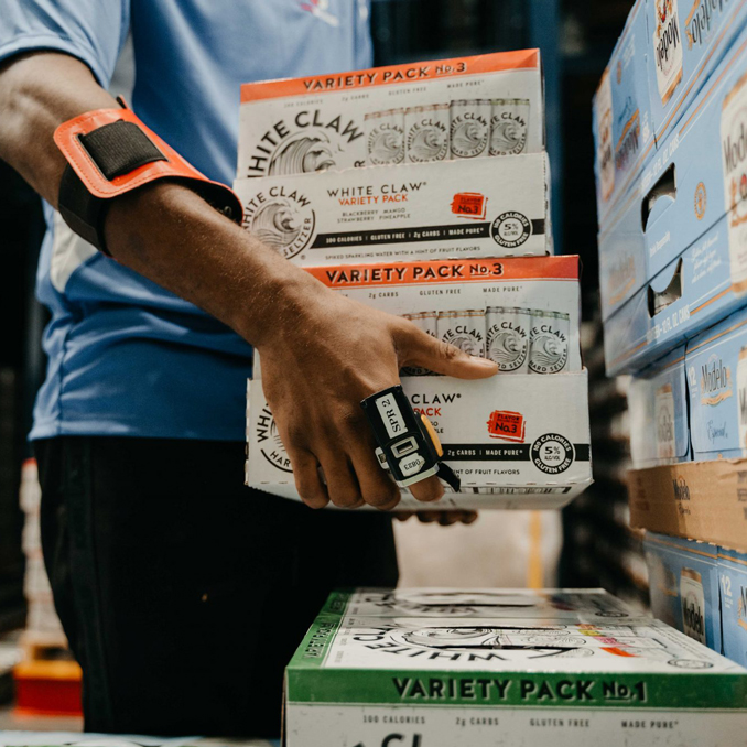 LongBev12_Mobile Close up of an employee stacking cases of White Claw